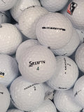 A close-up pile of white Srixon golf balls, with several balls visible showing the Srixon logo and model names like Marathon 2 and Marathon 4.